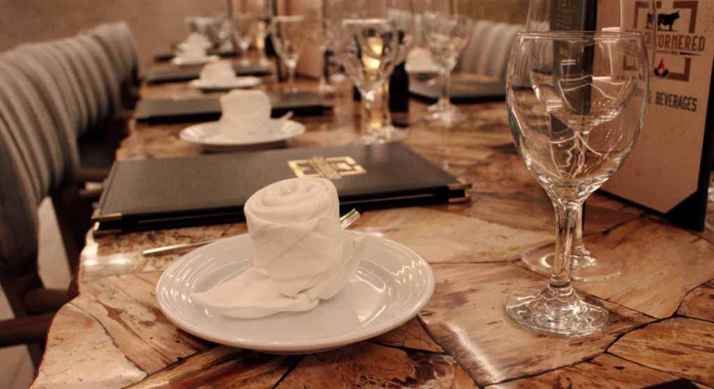 Four Cornered Steakhouse table with plates and silverware